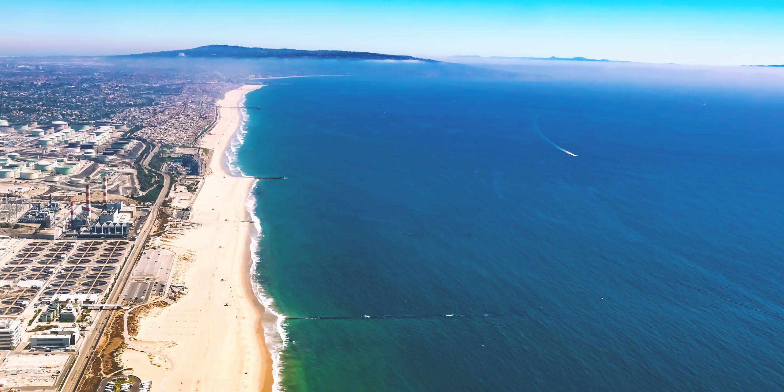 Aerial view of an oil refinery on the beach of El Segundo, Los Angeles, CA