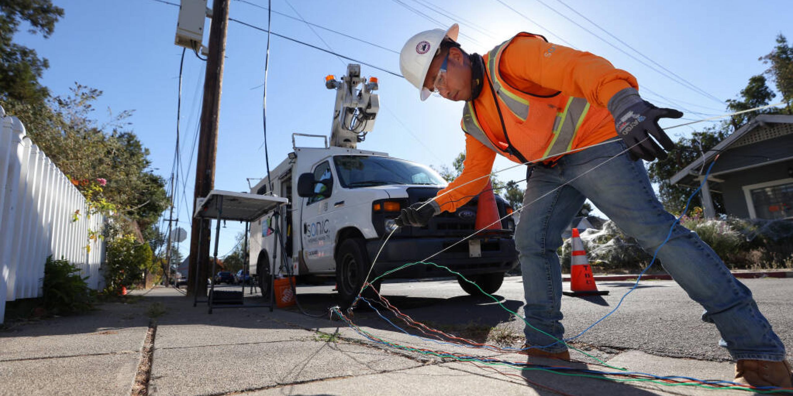 Sonic fiber splicing technician Thai Saengarun works on building Sonic's fiber optic infrastructure to bring high speed internet access to a neighborhood, at Brown and Charles streets, in Santa Rosa on Thursday, October 14, 2021.