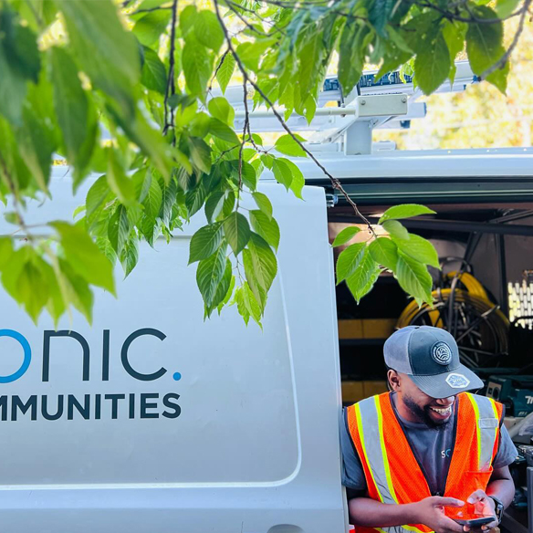 Sonic employee sitting in Sonic Communities installation van.