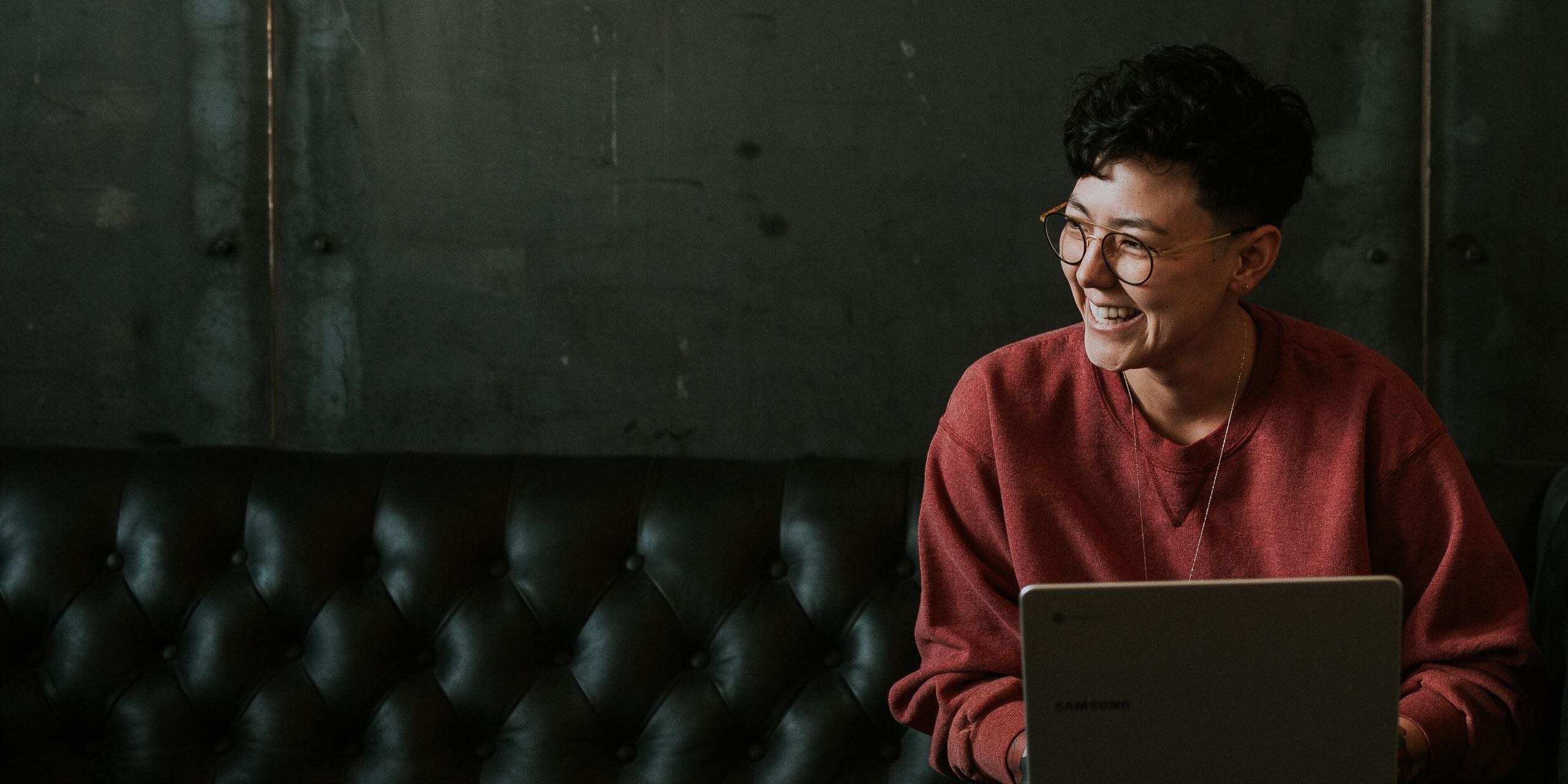 Woman on couch with laptop using Sonic Home Internet