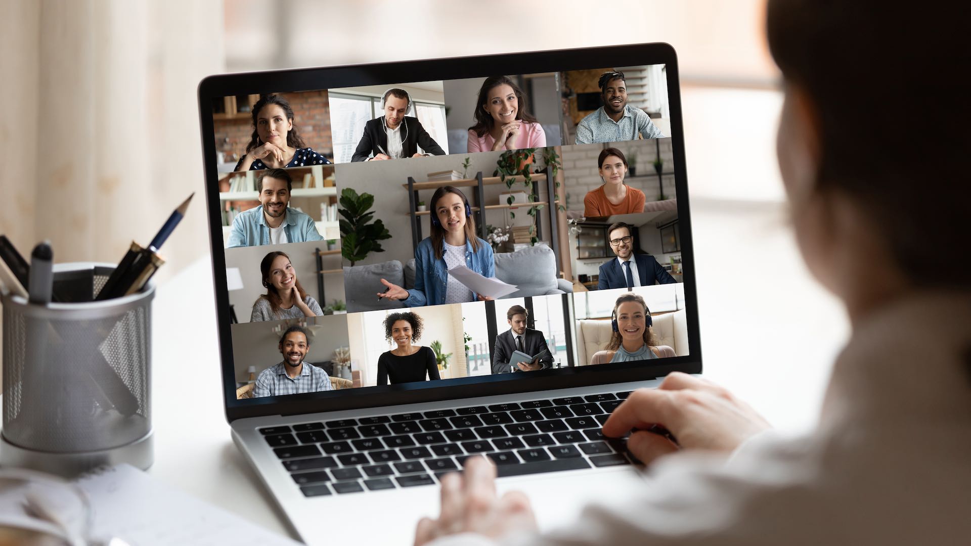 Female employee on webcam team meeting online.